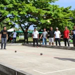 Exciting petanque action at fopikotabitung.org sport event with diverse players, showcasing community spirit.