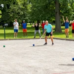 Exciting petanque match at fopikotabanjarba.org's outdoor event, showcasing vibrant community engagement.